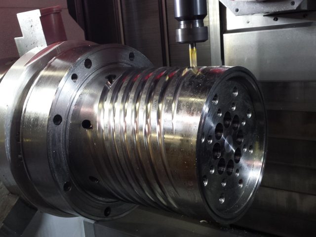 Spiral flow channels being milled into a 19in mandrel for a three-layer blown film die