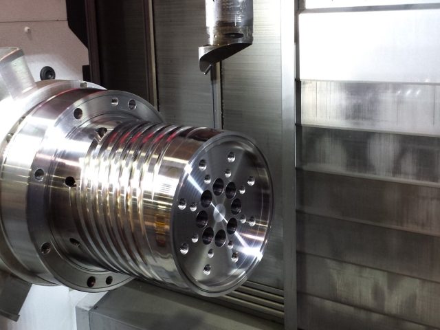 19in spiral mandrel set up under the live tool spindle, drilled port face toward the cutter