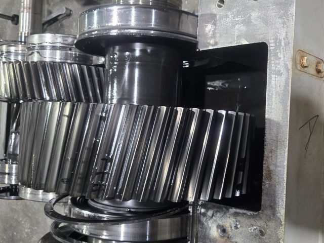 Helical gear stack removed from an extruder gearbox for measurement of tooth contact and journal diameters