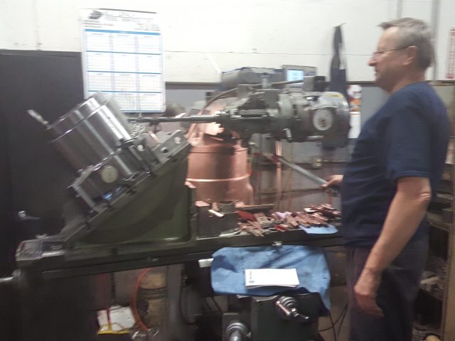 Machinist working on a large component in the shop