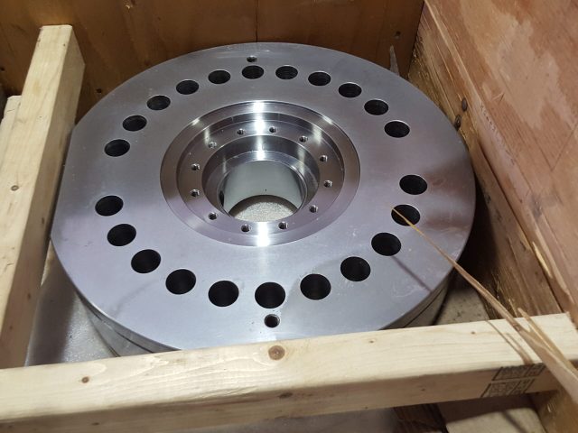 Machined bearing plate showing central bore and drilled bolt pattern