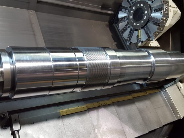 Splined shaft end held in the lathe chuck during turning
