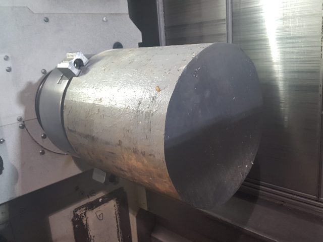 Rough steel billet mounted for first turning operations
