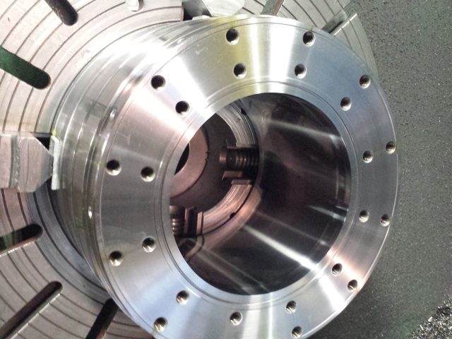 Three-layer blown film die body in the lathe chuck, flange face and bolt circle finish-machined