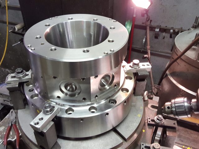 Flanged die assembly showing the bored centre and bolt pattern