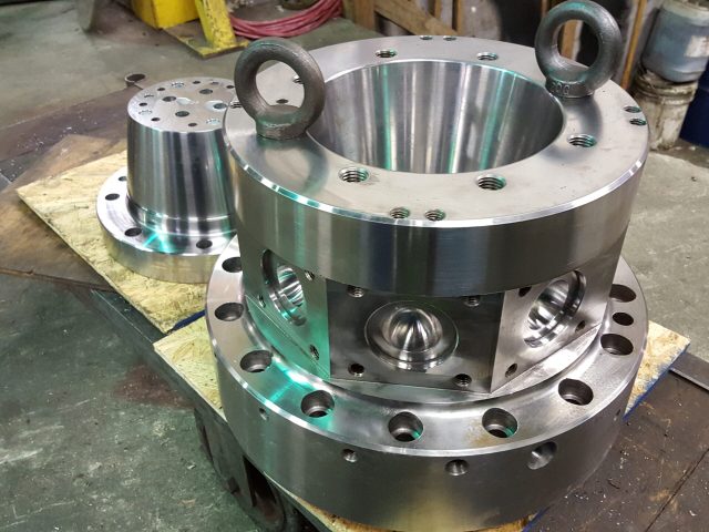 Large flanged extrusion die assembly on the bench