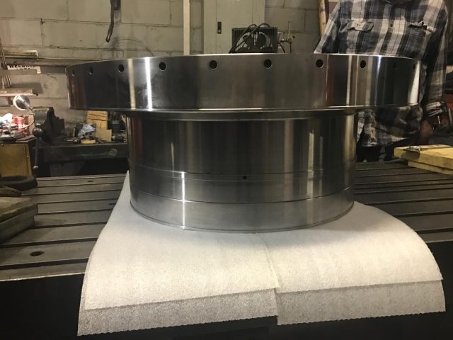 Large machined ring positioned on the machine table