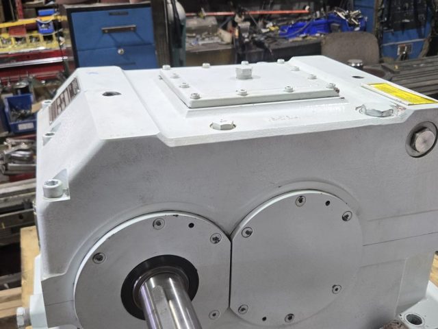 Rebuilt extruder gearbox assembled and painted on a pallet at Zala Machine Co.