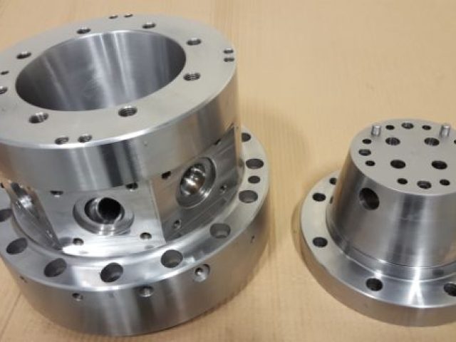 Machined manifold block with cross-drilled bores
