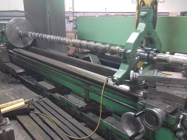 Long shaft supported in a steady rest during turning on the large lathe