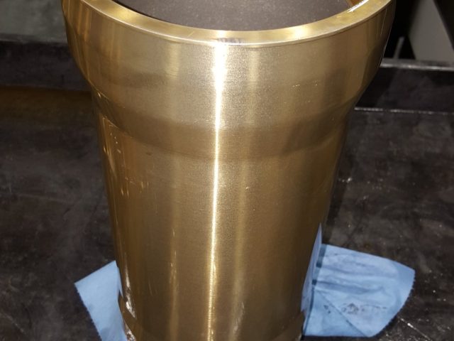 Tapered bronze sleeve bushing, threaded at the top rim and finished on the bench