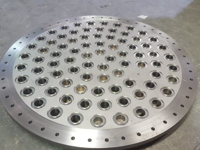 Large drilled tube sheet, every tube hole bored and chamfered inside the outer bolt circle