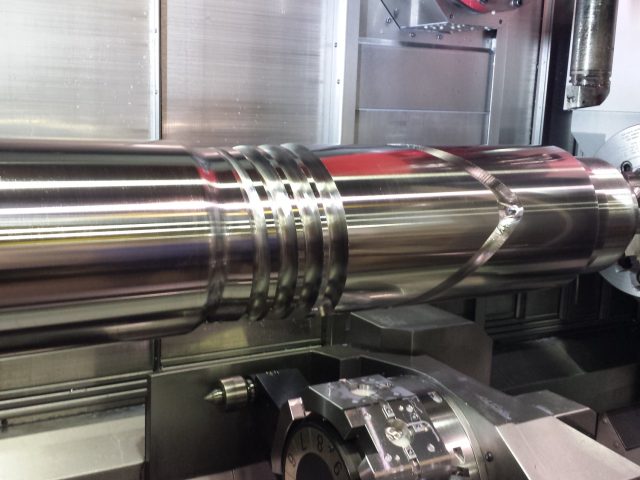 Extruder screw running in the CNC mill-turn, helical flights and mixing section cut on one setup