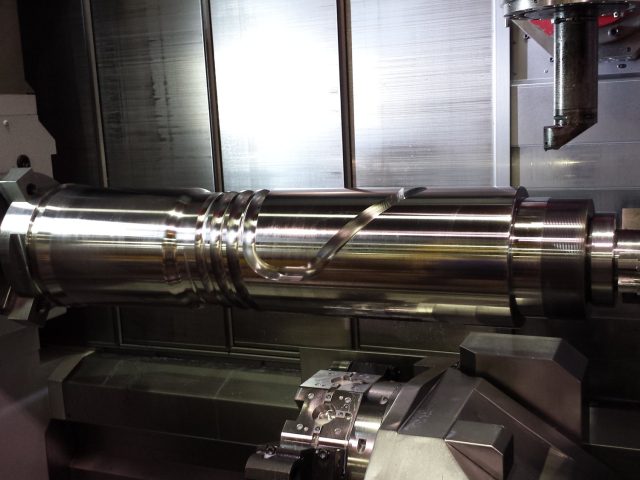 Extruder screw tip and flight run-out finished on the mill-turn, chuck holding the drive end
