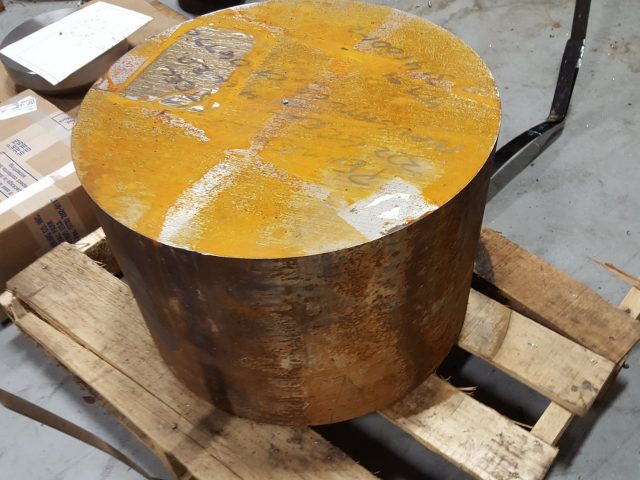 Round steel billet on the pallet, the starting stock for a three-layer blown film die block