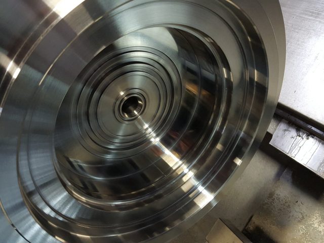 First side of the die block finished on the lathe, concentric flow steps turned in to the centre bore