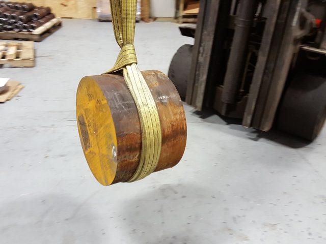 Die block billet slung from the forklift and moved across the shop floor