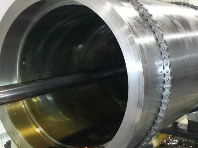 Large cylinder on the honing machine, hone inside the bore working the finish