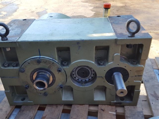Assembled industrial gearbox on the pallet with its output shafts and bearing in place