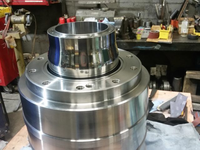 Die housing on the bench, stepped flanges and the finished bore at the neck