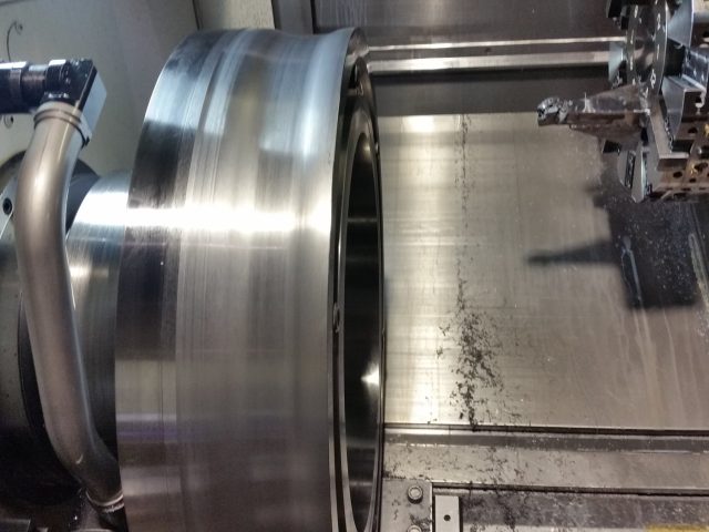 Large roll body turned on the CNC lathe, outside diameter cut down toward the shoulder