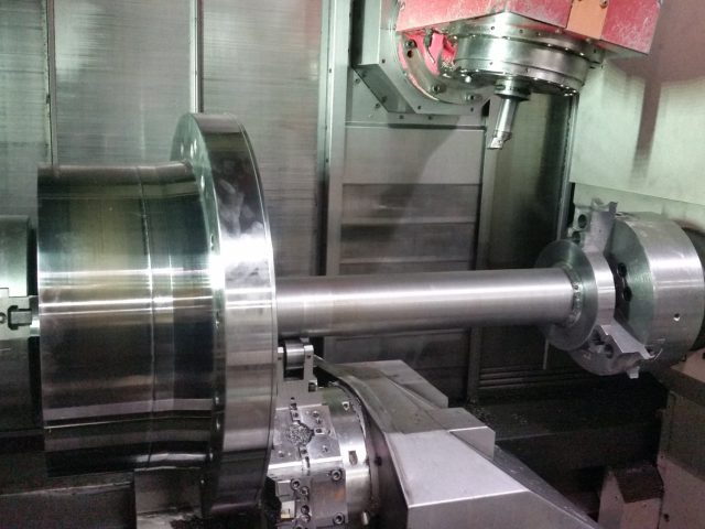 Shaft with a large integral flange machined between centres in the mill-turn