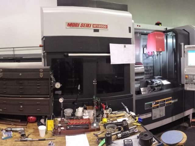 Mori Seiki NTX2000 mill-turn centre on the shop floor with the tool bench alongside