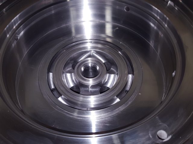 Inner face of a spiral mandrel, flow channels cut around the central hub