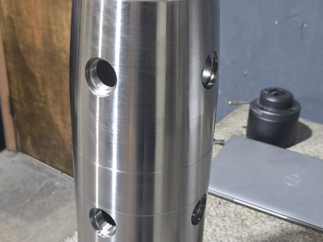 Stainless prototype sleeve with radial ports machined for a research project